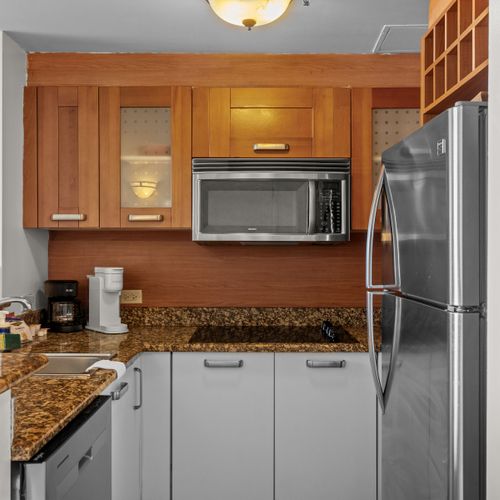 Seamless studio living. This wide-angle view showcases the thoughtful layout, connecting your comfortable sleeping area to a convenient and well-equipped kitchenette.