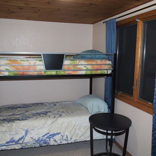 Bedroom #4 (upstairs):  features a twin-on-twin bunk bed, table, and a closet.