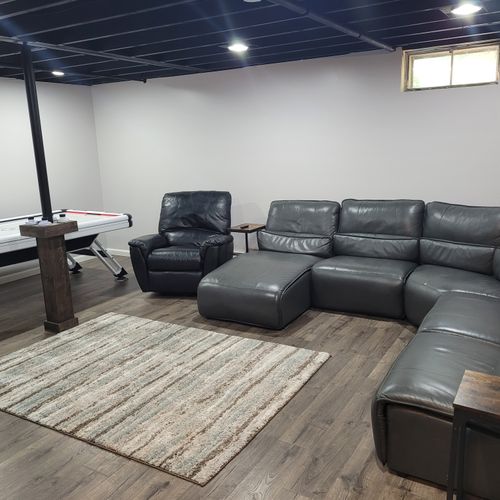 LOWER LEVEL:  Fully finished lower level with multiple sofas, multiple televisions, a foosball table, dartboard, and an air hockey table.