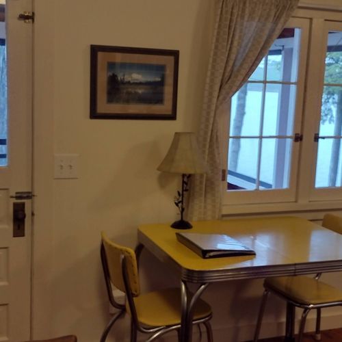 Living room:  the cabin has cute living room with a loveseat, dining table, comfy chair, and streaming television.