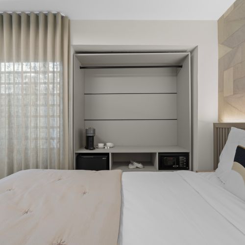 Well-appointed room with ample storage space and in-room coffee and tea making facilities.