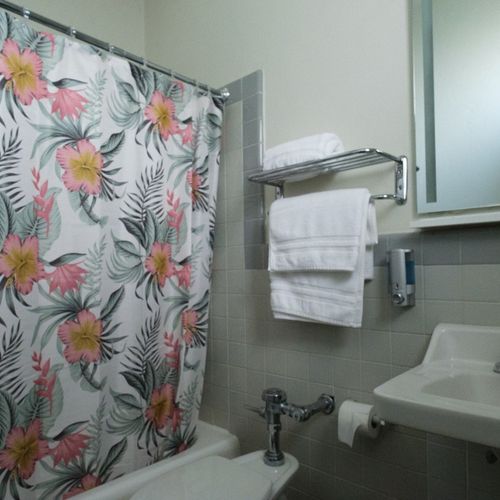 Refresh yourself in our meticulously clean bathroom, equipped with a spacious shower and a generous supply of soft, fresh towels for your complete convenience.
