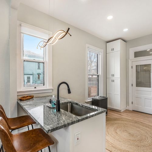 Sip in style at our wet bar, complete with a sink and two trendy bar stools.