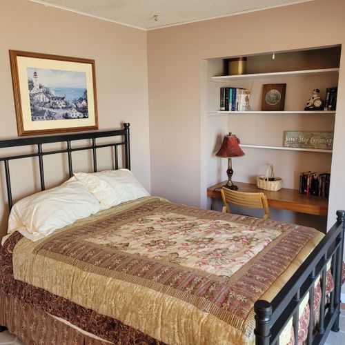 Bedroom #2 (first floor):  features a full-size bed, two closets, television, private entrance, and a great view of crystal lake!