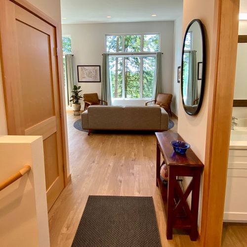Step inside and exhale — the welcoming foyer opens right into the light-filled living room beyond.