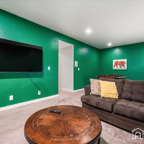 Relax in the modern downstairs lounge, complete with a large sectional, widescreen tv and foosball table.