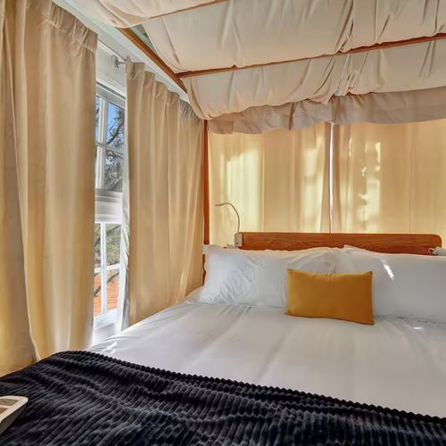 Sunlit canopy bed offering a peaceful retreat