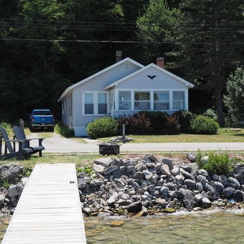 Overall:  the front of the cottage, highlighting the private dock and bonfire ring.
