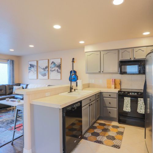 The equipped kitchen features a full sized dishwasher, stainless steel fridge, microwave, oven, coffee maker, and more!