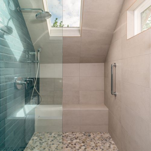 Its all about the light and comfort. With a bench for sitting and grab bars, this walk-in shower is a dream.