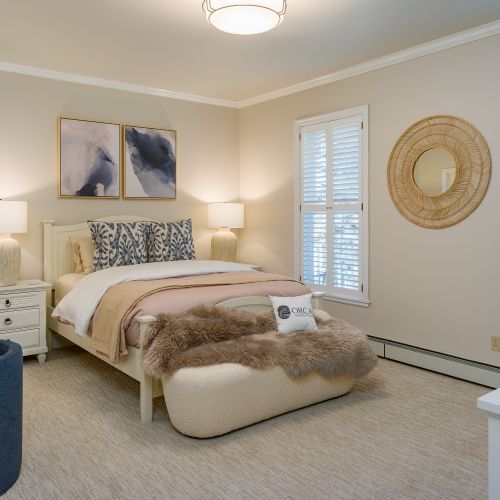 The main level master bedroom.  Queen bed with plantation shutters, desk and bathroom ensuite.