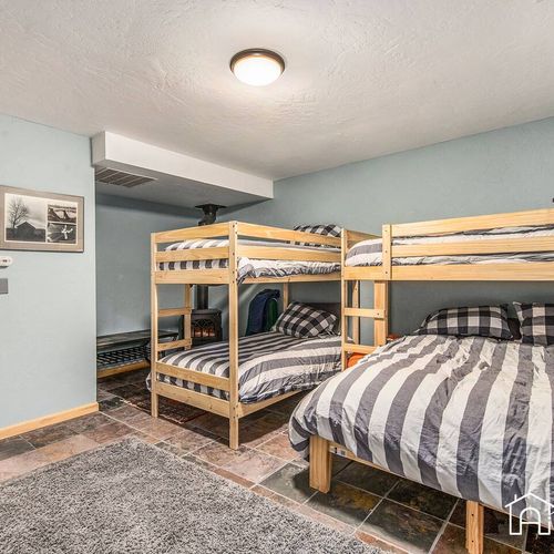 - view another angle of this inviting bunk room designed for group or family stays
- roomy layout with plush bedding, soft rug, and a warm mountain cabin vibe
- sleep soundly after a day of hiking, skiing, or lakeside adventures nearby