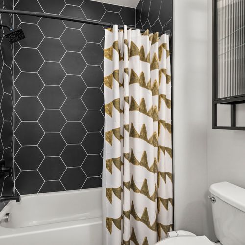 Bold design details add character and charm to this beautifully styled bathroom space.
