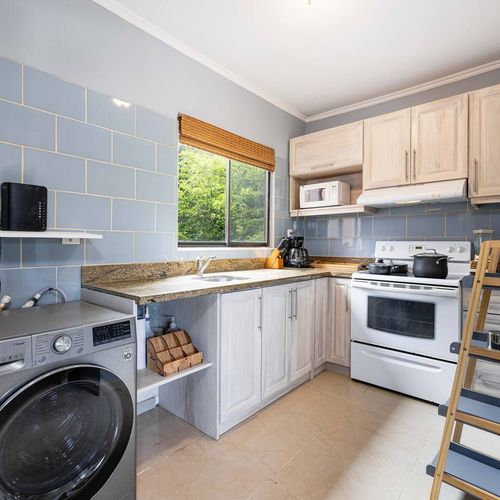 The unit has a nice kitchen with a washerto do the laundry at home!