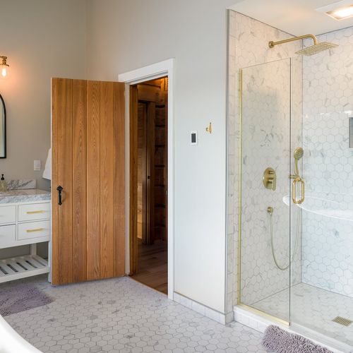 Master bedroom bathroom with Jack and Jill marble sink vanities, slipper tub and a standing shower