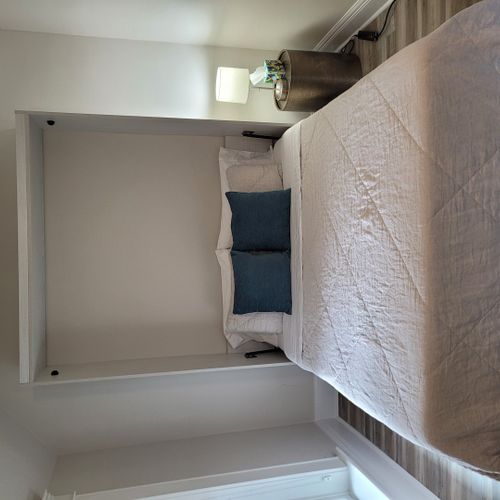 Bedroom #3 (second floor):  features a queen-size murphy bed, window a/c unit, ceiling fan, desk with chair, comfy chair, and a closet.
