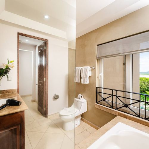 Downstairs Master bathroom with a tub