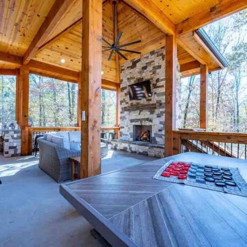 The upper level of the patio has sofas, a grill, checkers and more!
