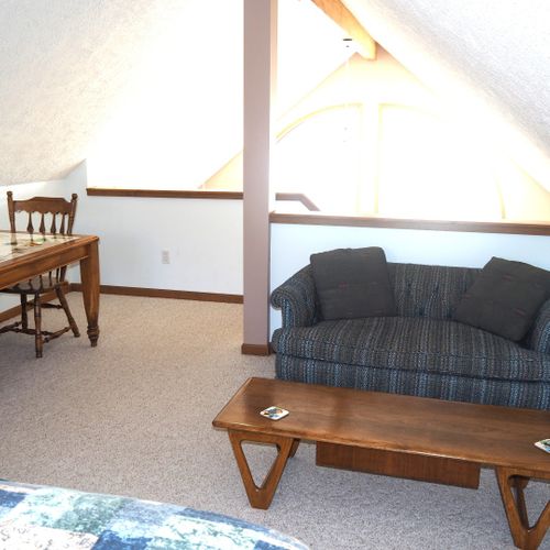 Loft:  there is a large loft area with a full-size bed, dresser, loveseat, chairs, and table.