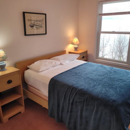 Bedroom #3 (upper level):  features a full-size bed, ceiling fan, closet, and great views of lake michigan.