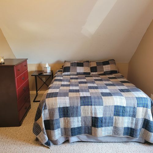 BEDROOM #2 (SECOND FLOOR):  Features a queen-size bed, 2 single beds, ceiling fan, a dresser, mirror, 2 nightstands, lamp, stool, and private live streaming television (via Sling).
