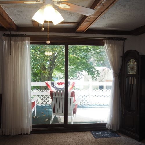 Living room:  includes a sofa, comfy chairs, live-streaming television, and entrance out to the deck.