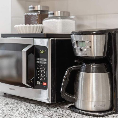 - morning right with a convenient coffee maker, filters, and microwave at the ready
- thoughtfully stocked with canisters, utensils, & everything you need to brew or reheat
- sleek stainless finishes & granite countertops keep the space clean & styli