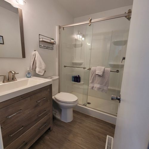 Full-bath:  the cottage has a lovely full bathroom with a shower, sink, vanity, mirror, and toilet.