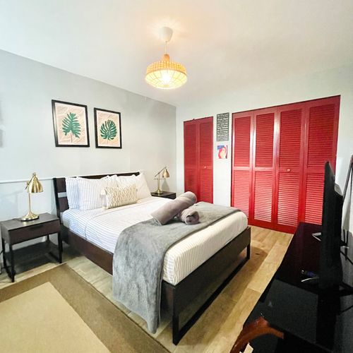 Unwind in comfort! Our spacious bedroom features a plush Queen-sized bed with crisp linens, promising a restful night's sleep after a day of adventure.