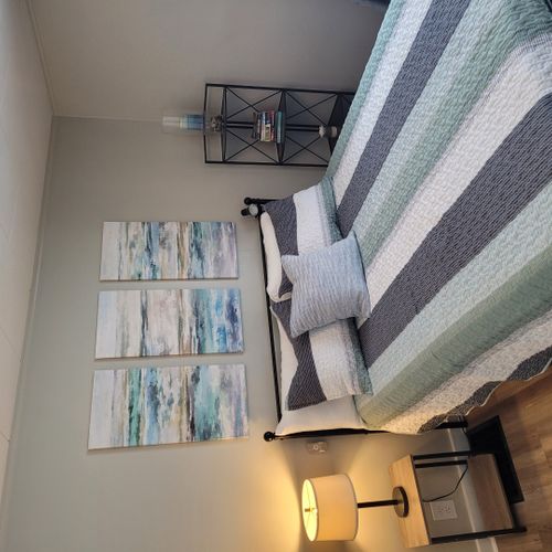 Bedroom #2:  features a queen-size bed, ceiling fan, nightstand, lamp, large closet, and 2 chairs.