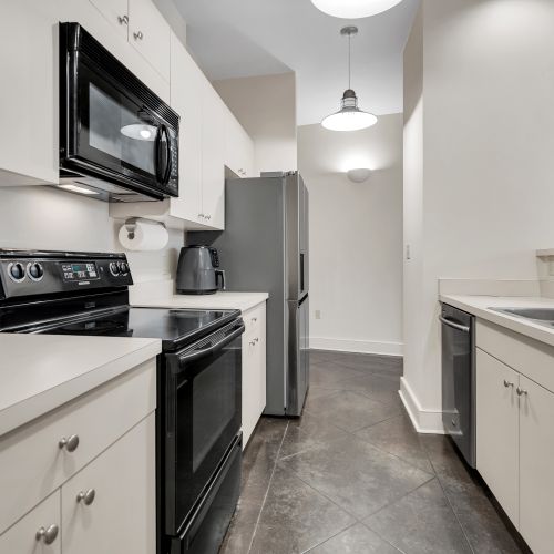 Fully equipped kitchen w/ stainless steel appliances ready for home-cooked meals.