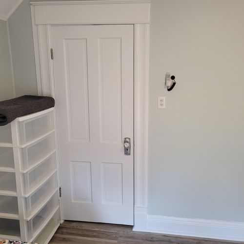 Bedroom #4 (second floor):  features a queen-size bed, twin bed, window a/c unit, ceiling fan, nightstand, lamp, dresser, and a closet.