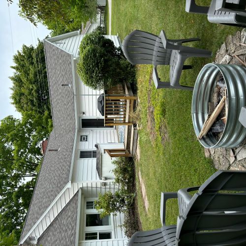 Exterior:  the backyard, backyard deck, and the fire pit in the backyard