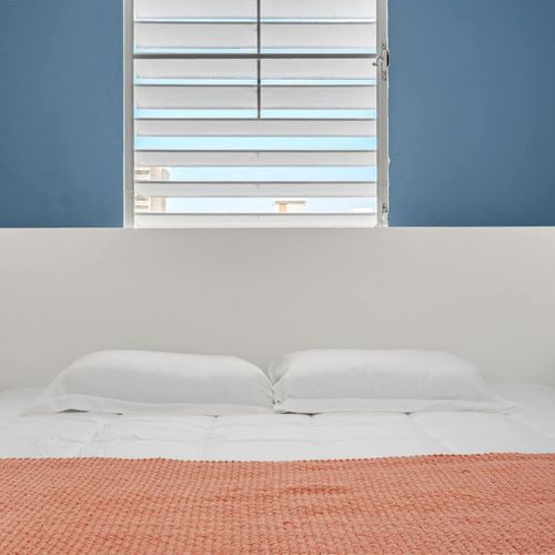 This inviting bedroom features two lamps for warm and adjustable lighting.