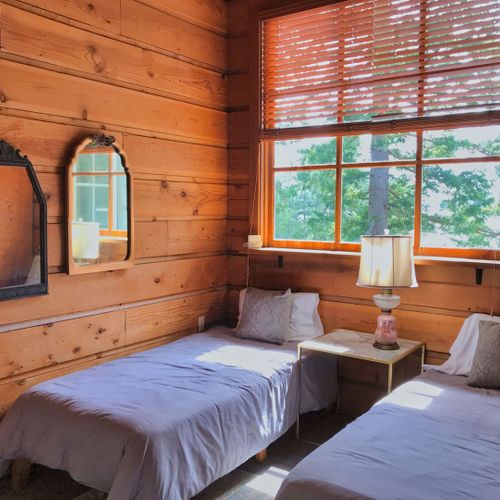 Guest bedroom with King bed and two single beds.