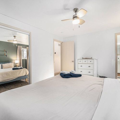 - rest easy in a light filled bedroom featuring a plush bed and spa like ensuite
- full length mirrored closet doors open up the space with a polished touch
- thoughtfully styled with calming neutrals, soft linens, and warm lighting