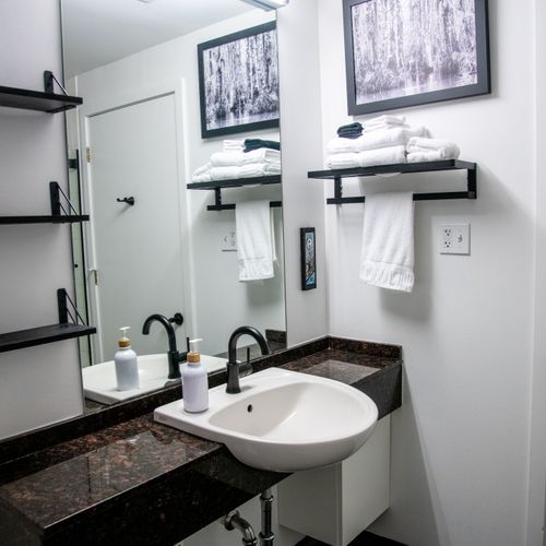 Bright bathroom w/ sink & modern fixtures — clean, simple & ready for your stay.