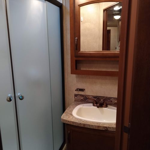 Bathroom #2:  full bathroom with a shower, sink, vanity, and toilet.