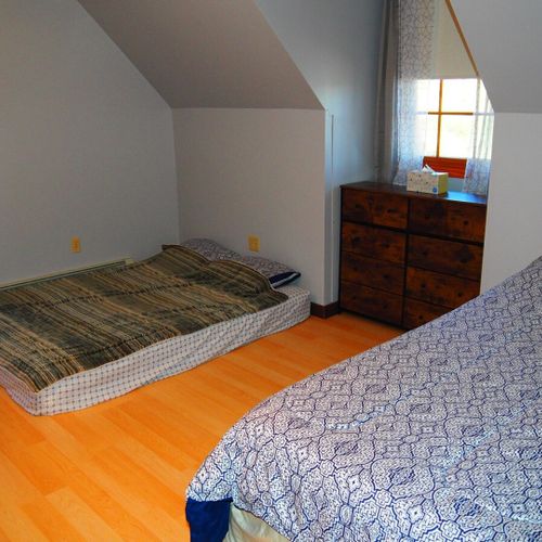 Bedroom #3 (second floor):  includes a queen-size bed, a full-size bed, and a twin-on-full bunk bed. Also has a dresser. Closet, and ceiling fan.