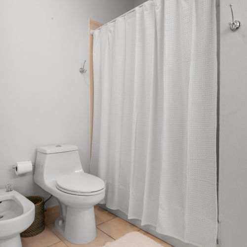 Our pristine bathroom provides a bright and private space for your daily routine, designed for convenience.