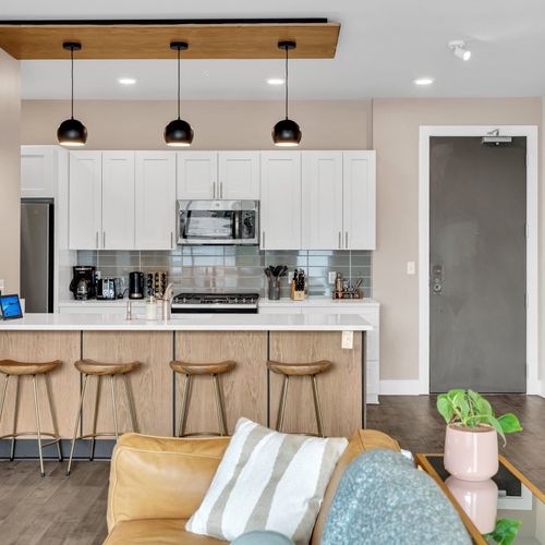 Sleek kitchen with a breakfast bar and modern amenities.