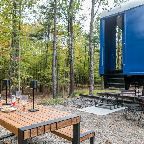 Fire pit and hammock located through the trees.