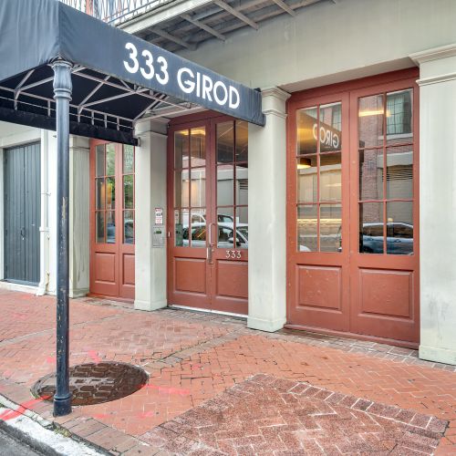 Step through the elegant wood & glass entrance of 333 Girod.