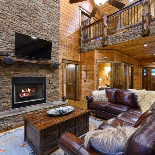 Oversized leather sectional around the stone fireplace!
