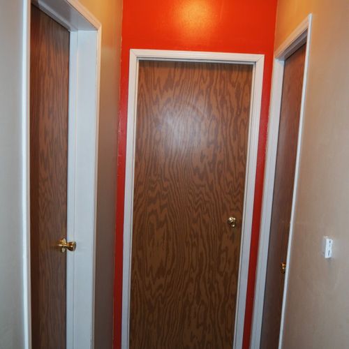 This photo shows the hallway that leads to bedrooms #2 and #3 as well as bathroom #2. The door on the left goes to bedroom #2, the middle door goes to bedroom #3, and the door on the right goes to bathroom #2.