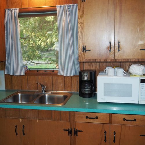 Kitchen:  the cottage has a cute little kitchen with all appliances except for a dishwasher. Includes a good supply of cooking and dining utensils.