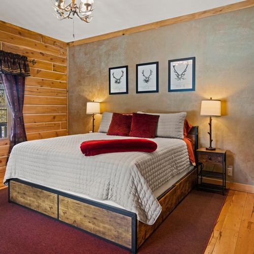 Bedroom #1 (main floor):  features a king-size bed, closet, and chair.