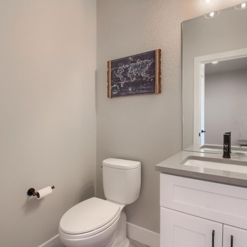 - simple and clean powder room with modern vanity and black hardware details