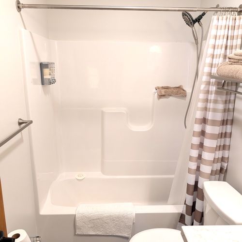 BATHROOM #3 (LOWER LEVEL):  Full bathroom on the lower level (first floor) with a combination tub and shower.