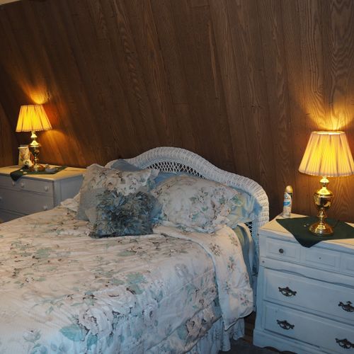 Bedroom:  includes a queen-size bed, dressers, night lamps, ceiling fan, closet, and room a/c unit.
